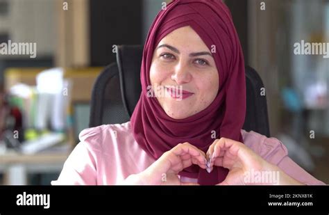 Friendly Smiling Beautiful Modern Arab Muslim Woman Shows The Heart Gesture With Stock Video