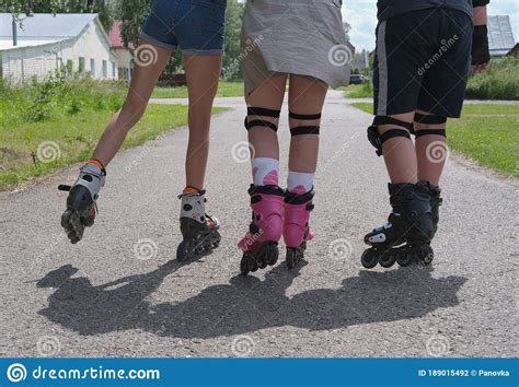 Cropped View Of Teenagers Moving In Roller Skates Stock