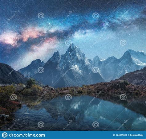 Milky Way Over Snowy Mountains And Lake At Night Landscape Stock Photo