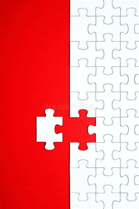 White Puzzle Pieces On A Red Background Separated Stock Photo Image