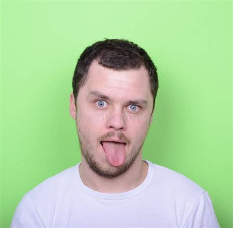 Portrait Of Man With Funny Face Against Green Background Stock Photo