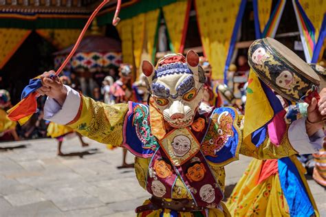 Monk Raising His Drum At Colorful Mask Dance At Yearly Paro Tsechu