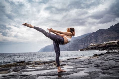 Active Sporty Woman Standing In Yoga Pose On The Rocks Slim Women