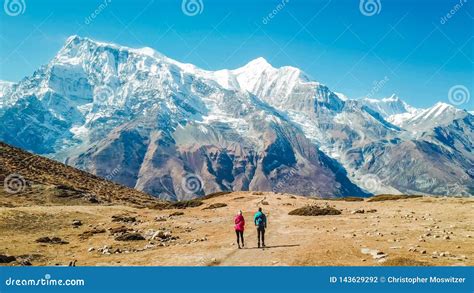 nepal couple and the ice lake with the view on annapurna chain editorial photography image