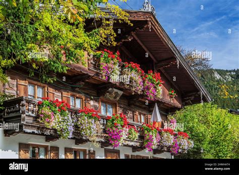 Typical Upper Bavarian Country House With Flowers In Birkenstein
