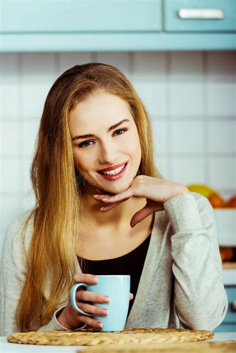 beautiful caucasian woman is sitting by table with cup of coffee stock image image of lady