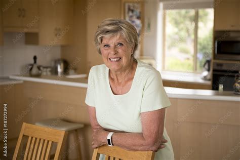 beautiful portrait of pretty and sweet senior mature woman in middle age around 70 years old