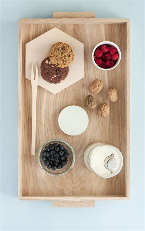 A Wooden Tray Topped With Cookies Berries And Yogurt Next To Other Foods