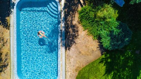 Aerial Drone View Of Little Girl In Swimming Pool From Above Kid Swims