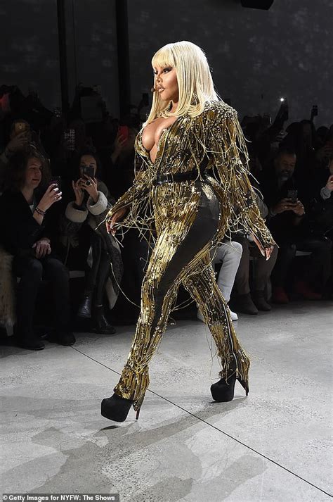 Rapper Lil Kim Puts On A Very Busty Display In A Plunging Gold Jumpsuit As She Performs At New