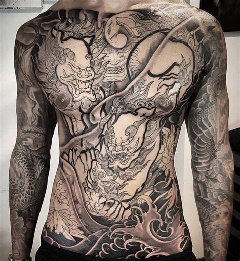 A Man With Lots Of Tattoos On His Back