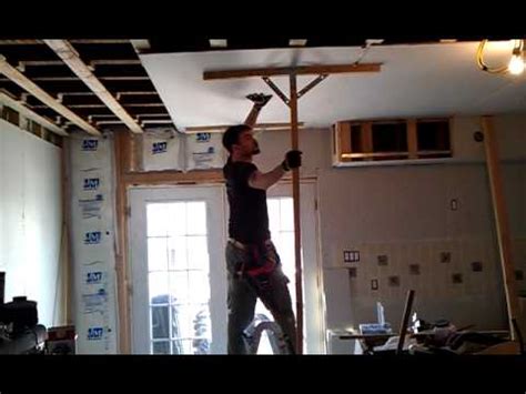 Hanging a drywall ceiling is a strenuous activity which should be done with a working partner. That is how it is done. Sheetrock to ceiling with two ...