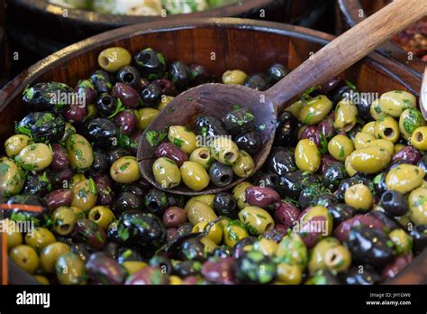 Olives In Wooden Bowls With Serving Spoon Stock Photo Alamy