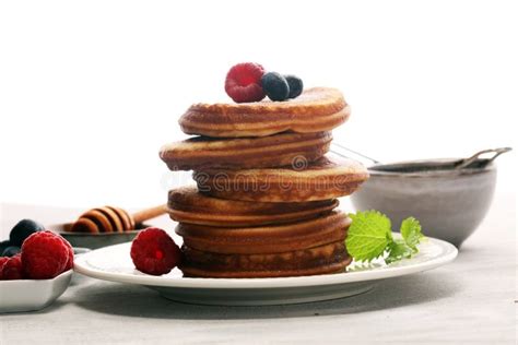 Pancakes With Berries And Maple Syrup On Rustic Table Stock Image