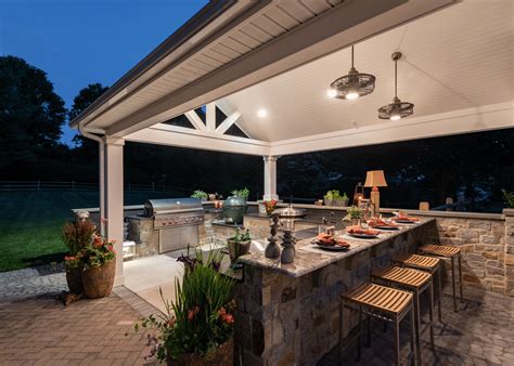 Make sure that you build your kitchen nearby the plumbing and electricity lines for a cheaper cost. outdoor-kitchen-under-roof - Gasper Landscape Design & Construction