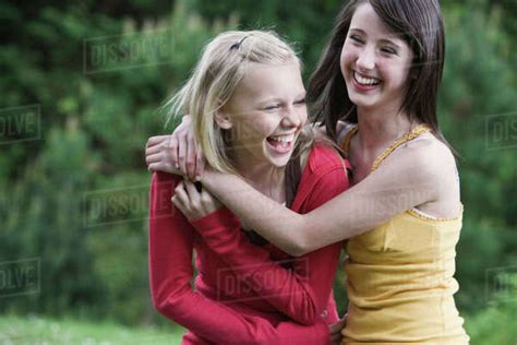 Girls Laughing In Park Stock Photo Dissolve
