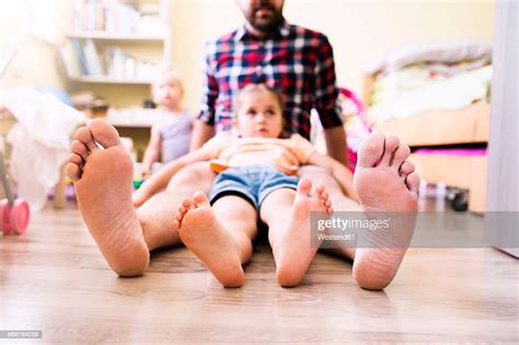 Father And Daughter At Home Showing Their Bare Feet Photo Getty Images