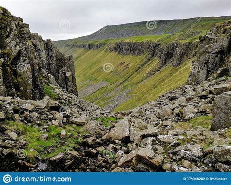 A Rocky Ravine Leading To An Expansive Cliff Lined Valley Stock Photo