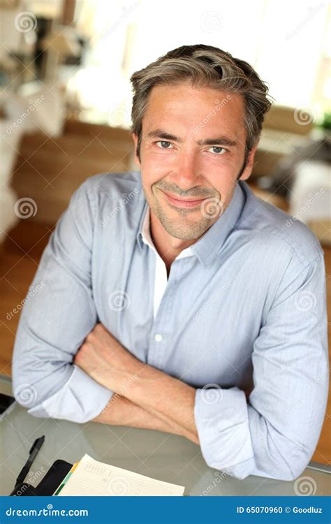 Handsome Man Sitting At Desk Stock Photo Image Of Happy Attractive
