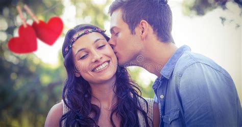 Composite Image Of Cute Couple Kissing In The Park Stock Image Image Of Beautiful Fondness