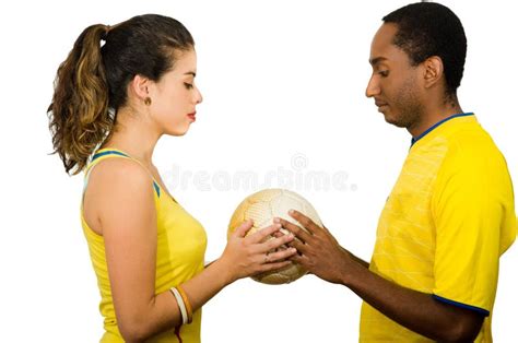 Charming Interracial Couple Wearing Yellow Football Shirts Embracing Friendly While Posing For