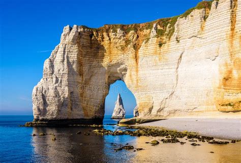 The Needle Seen Through The Arch Of The Manneporte Cliff In Etretat