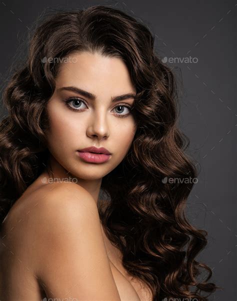 Beautiful Young Woman With Long Curly Brown Hair Stock Photo By Valuavitaly