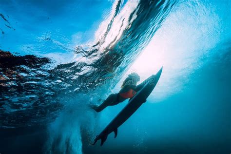 Surfer Girl With Surfboard Dive Underwater With Fun Under Big Ocean