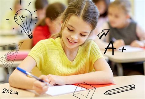 Group Of School Kids Writing Test In Classroom Stock Image Image Of