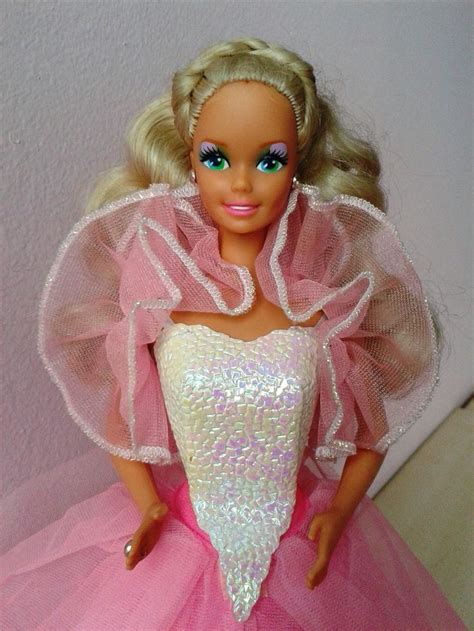 A Barbie Doll Wearing A Pink Dress With White Sequins On Its Skirt