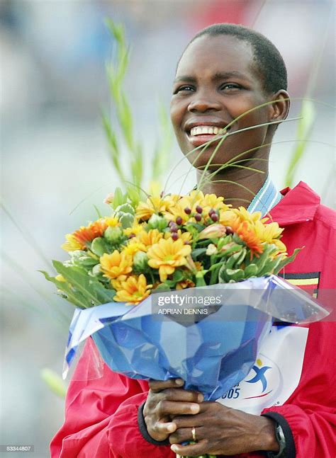 Ugandas Gold Medalist Docus Inzikuru Smiles On The Podium Of The