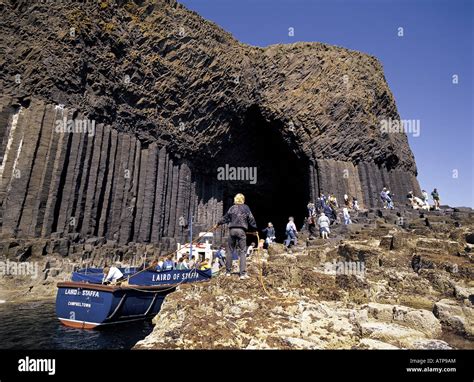 Tourists Alight From Boat At Fingals Cave On Staffa Island Scotland