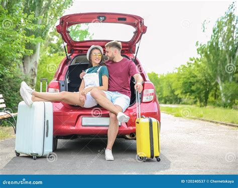 Beautiful Couple With Suitcases Packed For Summer Journey Sitting In Car Trunk Stock Image