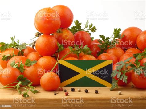 Jamaican Flag On A Wooden Panel With Tomatoes Isolated On A White