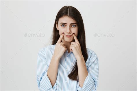 Indoor Portrait Of Unhappy And Stressed Woman With Frowned Eyebrows