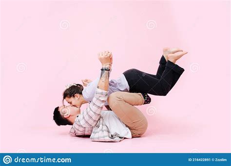 Adorable Couple Kissing In A Gymnastic Position Guy Holding Girl On