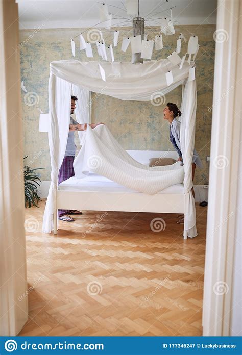 Couple Having Fun While Preparing Canopy Bed Stock Image Image Of
