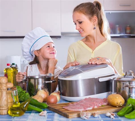 Girl And Mom Cooking With Multicooker Stock Image Image Of