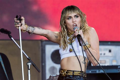 miley cyrus flashes fans shows off toned abs in beige top to celebrate charlie s angels song