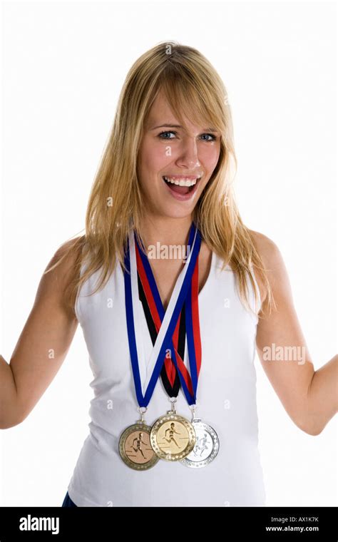 A Female Athlete Wearing Three Winning Medals Stock Photo Alamy