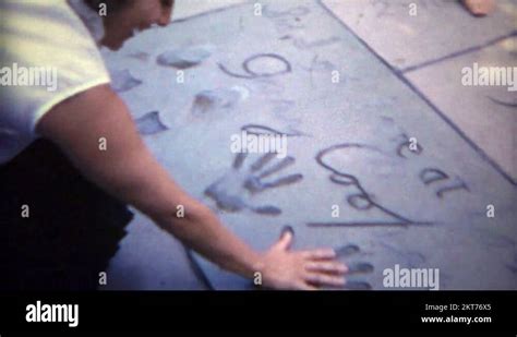 1965 Women Visits Walk Of Fame Actor Handprints Of Gary Cooper Hollywood Stock Video Footage