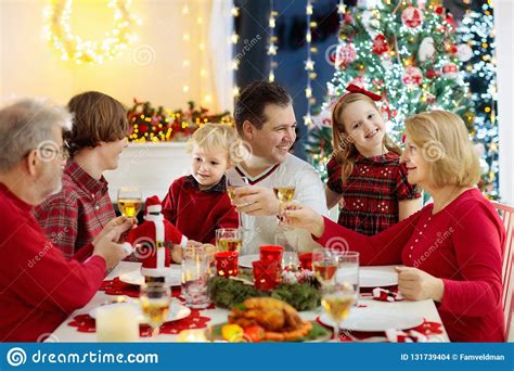 Your christmas dinner kids stock images are ready. Family With Children Eating Christmas Dinner At Fireplace And Decorated Xmas Tree. Parents ...
