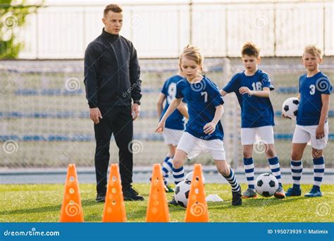 Young Coach With Clipboard Teaches Children Strategy Playing On