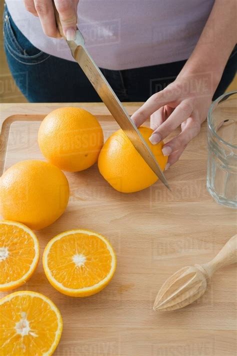 Woman Cutting Oranges Stock Photo Dissolve