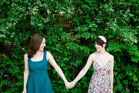 Two Women Holding Hands In Park By Stocksy Contributor Jennifer