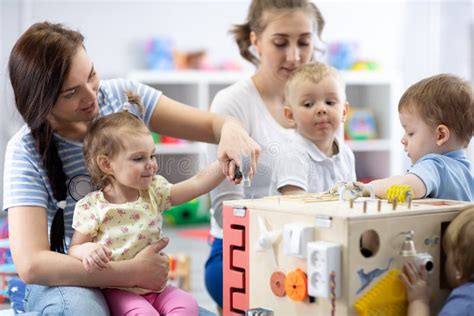 Babies Group Playing In Day Care Centre Or Nursery Stock Photo Image