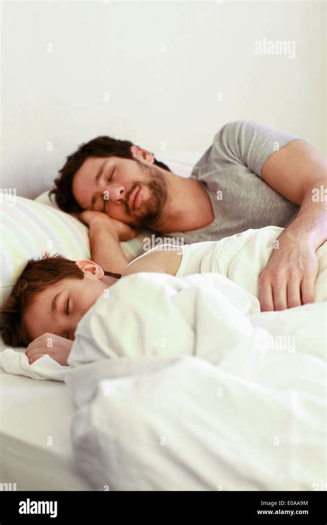 Father And Young Son Sleeping In Bed Stock Photo Alamy