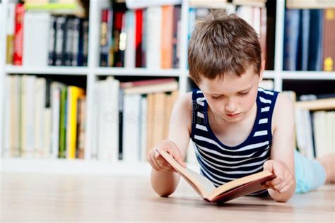 Seven Years Old Boy Reading A Book In Library Stock Image Image Of