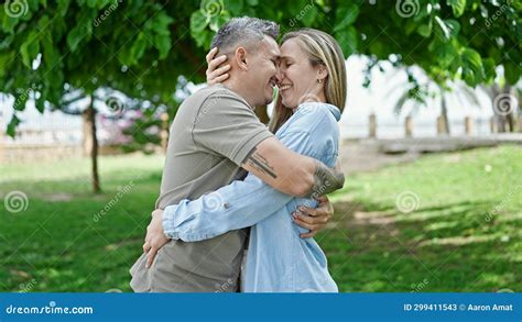 Man And Woman Couple Hugging Each Other Smiling At Park Stock Image