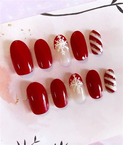 Six Red And White Nails With Snowflakes On Them